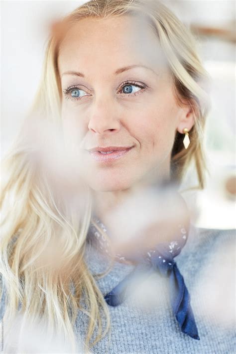 "Closeup Portrait Of Mature Woman With Blonde Hair" by Stocksy