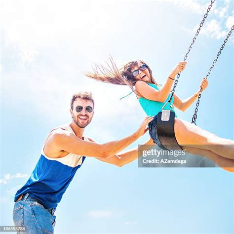 couple swinging  swing stock  high res pictures
