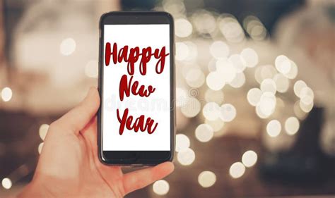 Happy New Year Text Sign on Hand Holding Smart Phone with Empty Stock ...