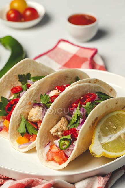 homemade mexican tacos  fresh vegetables  chicken  white