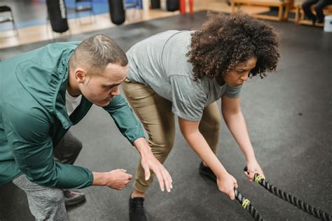 determined black woman exercising  battle ropes  workout