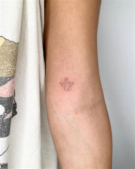 Little minimalistic cherub tattoo placed on the inner