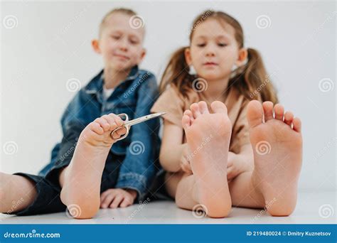 cute kids  bare feet boy  holding scissors  toes reaching