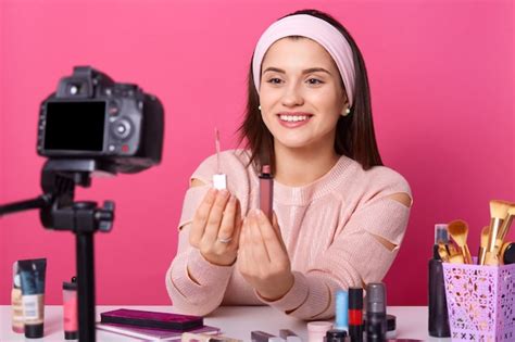 photo portrait  smiling young woman showing lipstick  camera