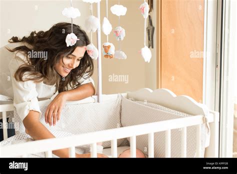 Mother putting baby to sleep at the crib Stock Photo - Alamy