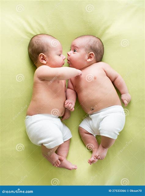 Twins Are Infants. A Close-up Photo Of The Legs Of Newborn Twins ...