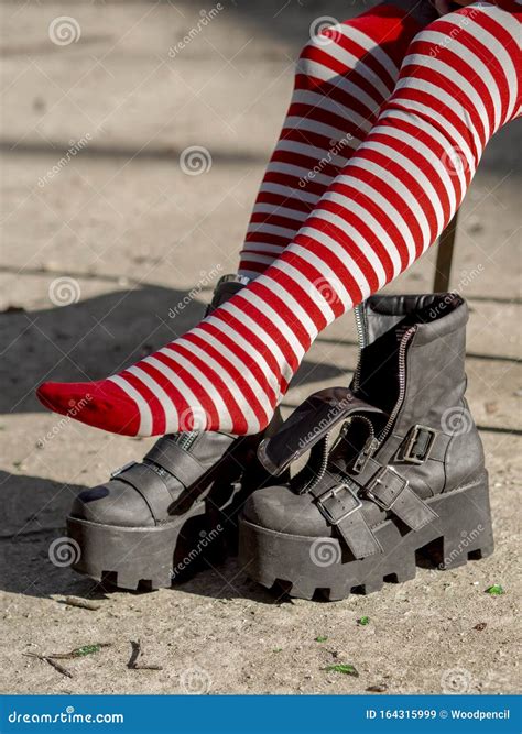 Close Up Vertical Shot Red and White Striped Stockings Feet and Heel