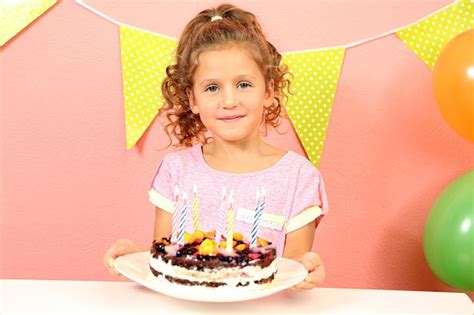 Premium Photo | Funny little girl with birthday cake at home