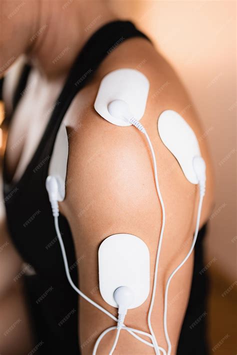 Premium Photo | Shoulder physical therapy with tens electrode pads