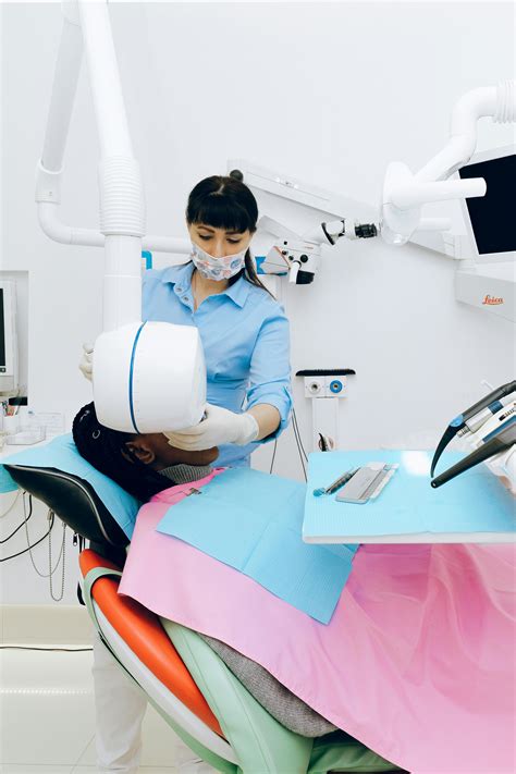 Female dentist working in modern office with patient · Free Stock Photo