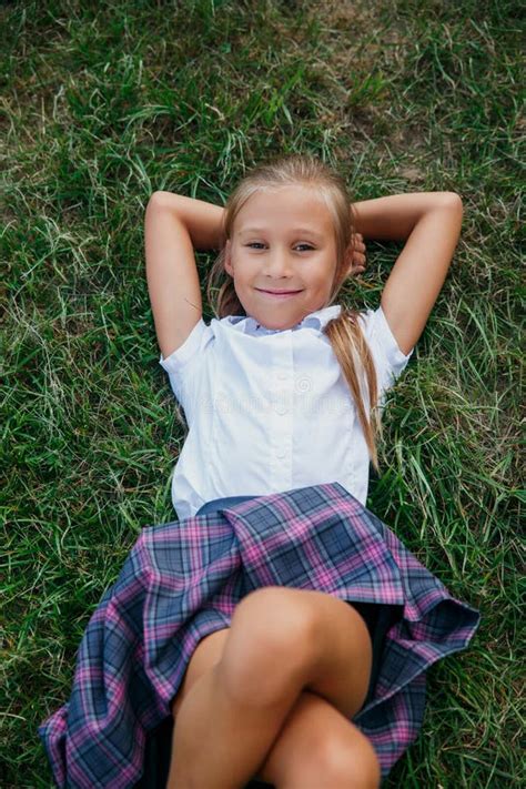 Back To School. Cute Girl from Elementary School Lying at Grass Stock ...