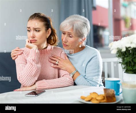 Senior mother encouraging her upset daughter Stock Photo - Alamy