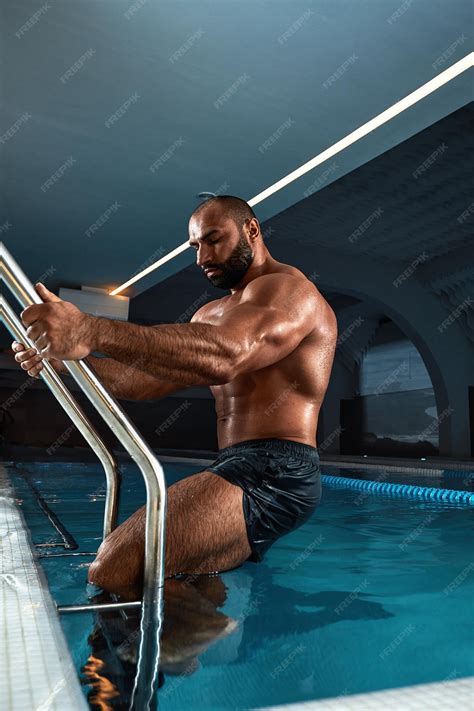 Premium Photo | Portrait of a wet sexy muscular man standing in