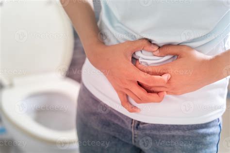 Constipation and diarrhea in bathroom. Hurt woman touch belly stomach