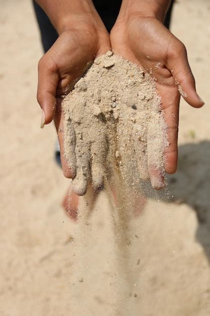 premium photo  section  person spilling sand  beach