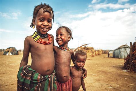 Three little girls from Dassanech tribe looking at camera while ...