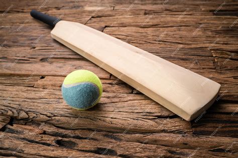 Premium Photo | Cricket Bat And Ball On Wooden Background