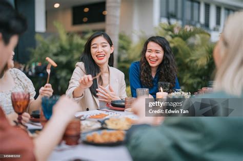 asian chinese lesbian couple  friends enjoying outdoor dining