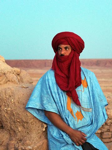 Berber Nomad Man Wearing Traditional Clothes Poses In Sahara Desert ...