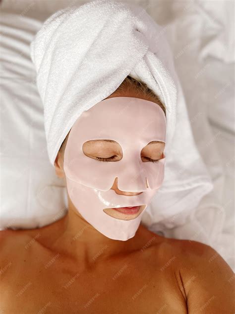 Premium Photo | Woman laying in bed wearing a face mask