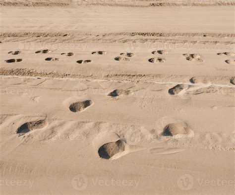 Traces of people in the sand of a beach. Pure sand on the beach as a