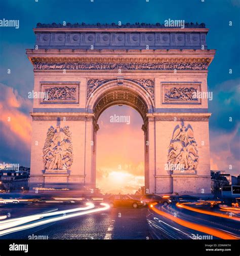 View of famous Arc de Triomphe at sunset, Paris Stock Photo - Alamy