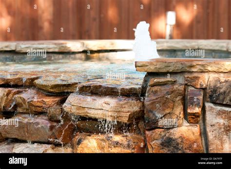 Swimming pool spa with waterfall and fountain Stock Photo - Alamy