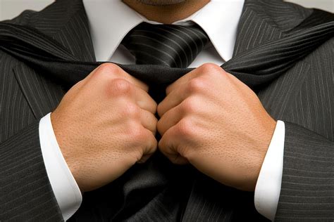 Businessman adjusting his tie capturing the ritual of preparation and precision in professional ...
