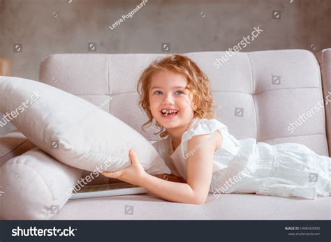 Little Girl Lying On Couch Stock Photo 1998569993 | Shutterstock