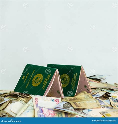 Multiple Ecowas Nigeria International Passport on a Heap of Local Naira