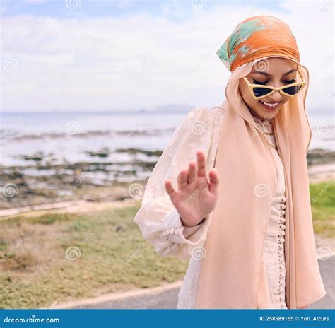 Beautiful Young Arab Woman Posing Outdoors in a Headscarf. Attractive