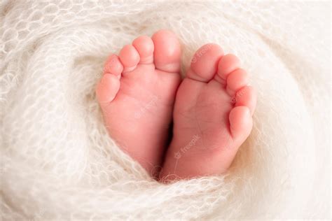 Premium Photo | Soft feet of a newborn in a white woolen blanket ...