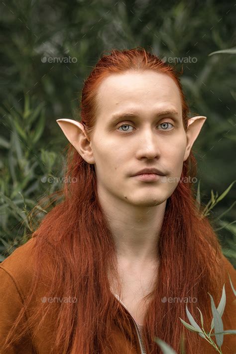 Artistic elf man with red hair and green eyes in the forest Stock Photo ...