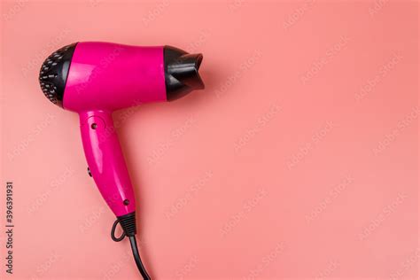 Pink hair dryer on a pastel pink background. Top view Stock Photo ...