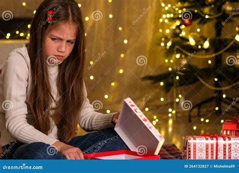 Kid Girl Opening Christmas Gift in Decorated Room and Gets Upset Stock ...