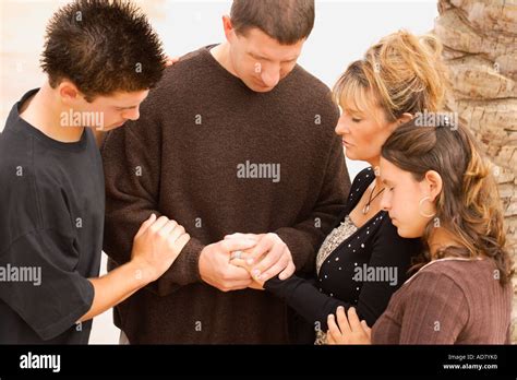 A group of young people praying together Stock Photo - Alamy