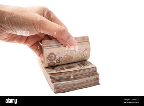 asian hand  stack  thai baht banknotes  white background