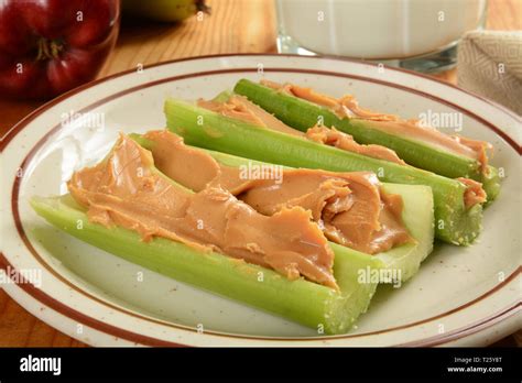 Crispy celery sticks with organic peanut butter and milk Stock Photo - Alamy