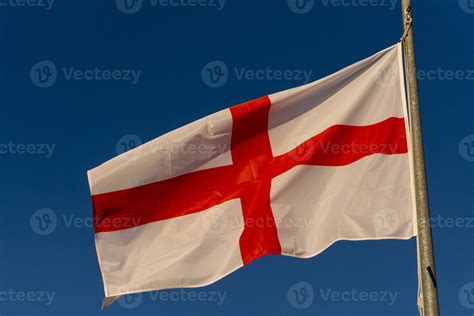 waving english flag red cross on white isolated on blue 18806354 Stock