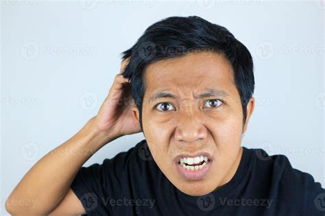 funny facial expression of asian man confused and scratching his head