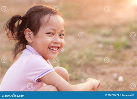 A Cute Little Girl Smiling and Laughing Happily in the Evening with ...