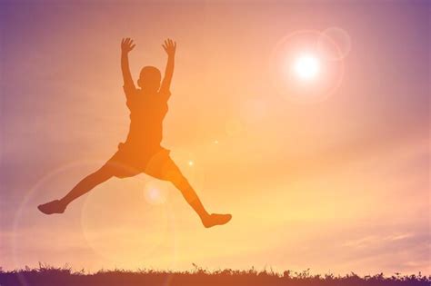 premium photo child jumping  sunset