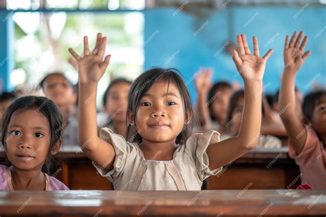 Premium Photo | Children in Classroom Raising Hands