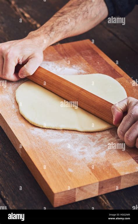 Making handmade pasta with wooden rolling pin Stock Photo - Alamy