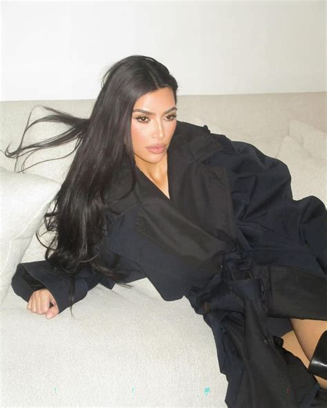 Kim Kardashian goes pantless as she sprawls on the couch in just thigh