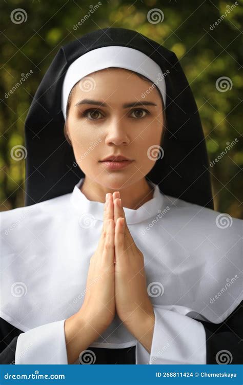 Young Nun with Hands Clasped Together Praying Outdoors Stock Photo ...