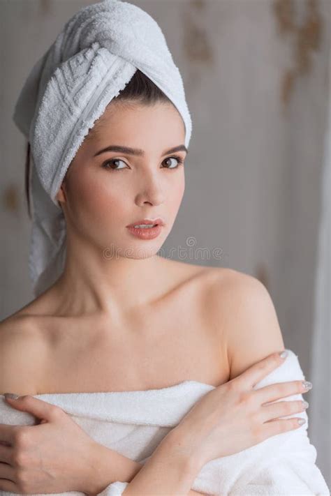 Young Woman Partially Dressed in Robe, Taking Care of Her Legs after ...