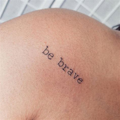 "Be brave" lettering tattoo on the shoulder