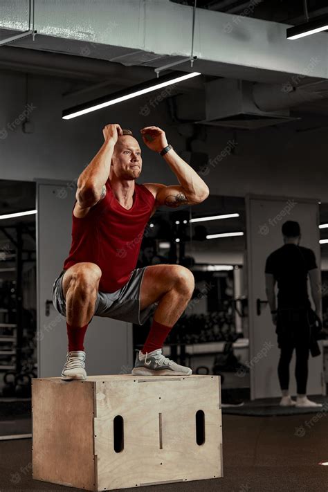Premium Photo | Sexy muscular men using the platform for his legs on a