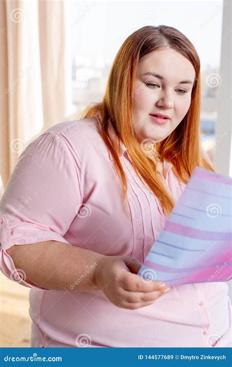 Nice Plump Young Woman Reading a Magazine Stock Image - Image of ...